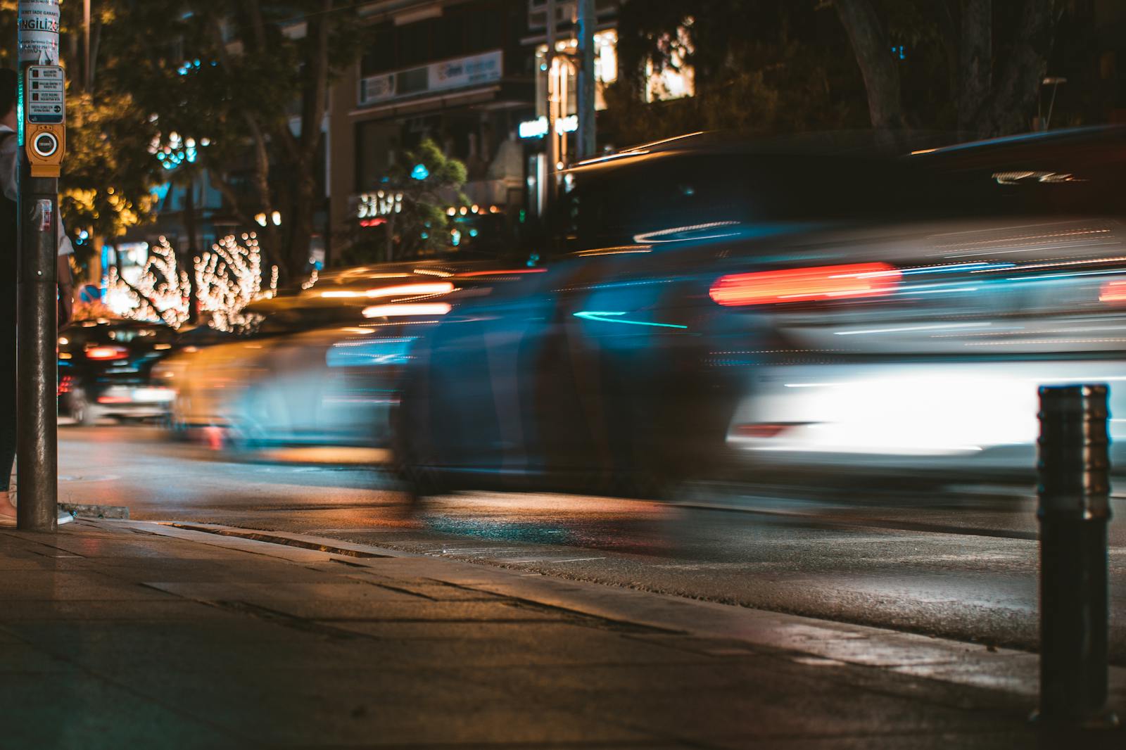 insurance, Long exposure capture of urban traffic showcasing light streaks and busy city life at night.